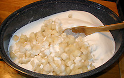 Mixing pears, pineapple juice, and sugar